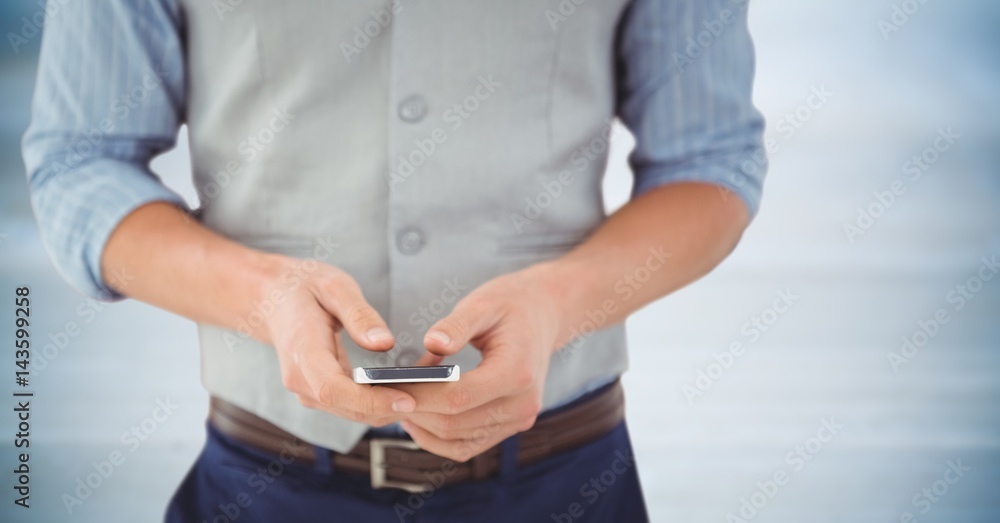 Man mid section with phone against blurry blue wood panel