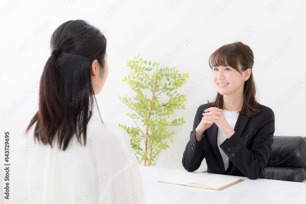 asian businesswomen talking in office