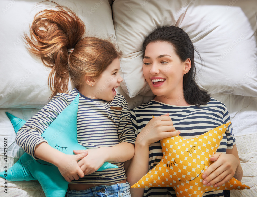 Mom and her daughter are playing