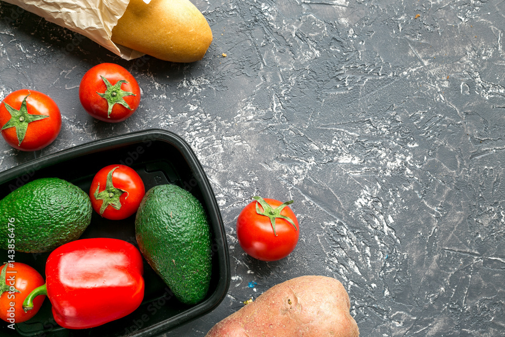 vegetables in plastic tray on gray desk background top view mock-up