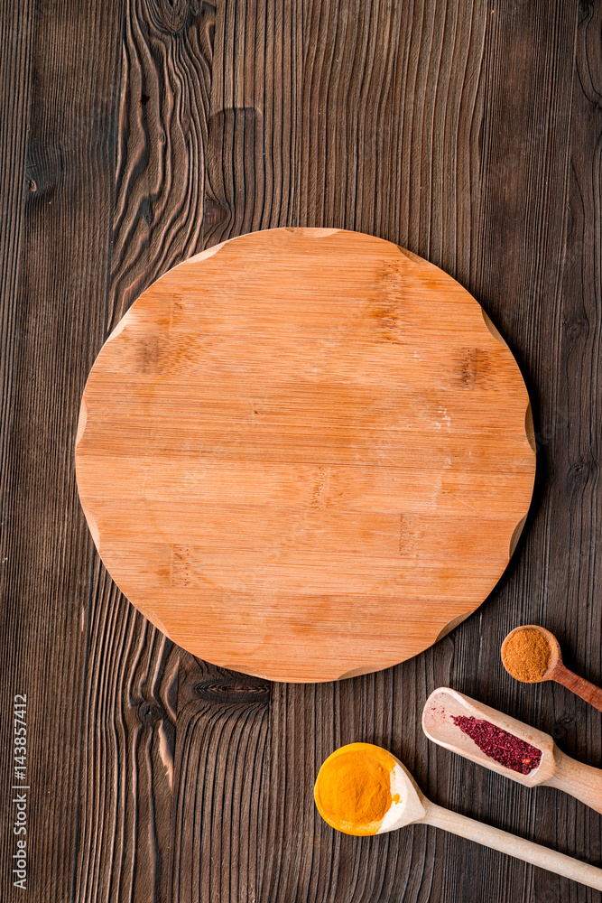 Professional kitchen with spices for cook on wooden background top view mock-up