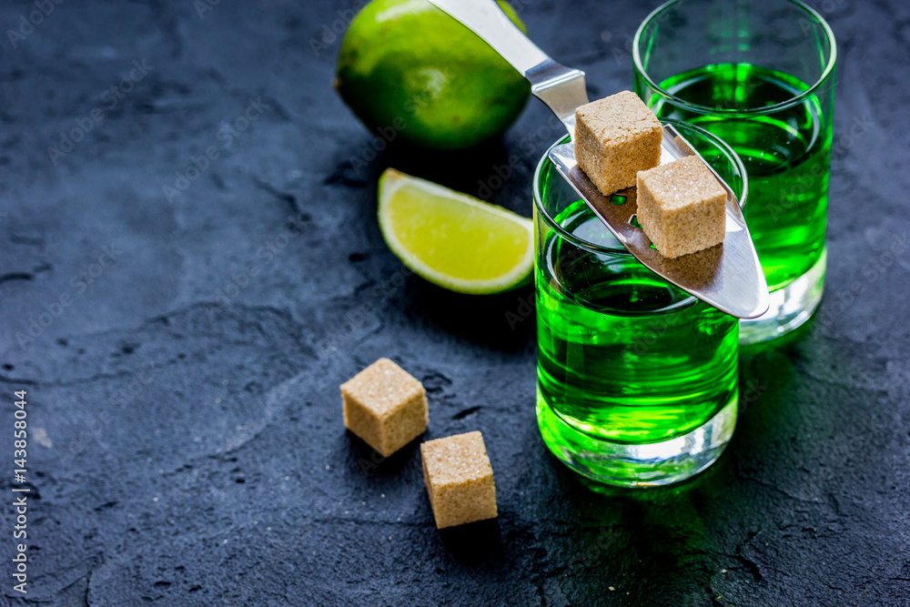 absinthe shots with lime slices and sugar on dark table background mock-up