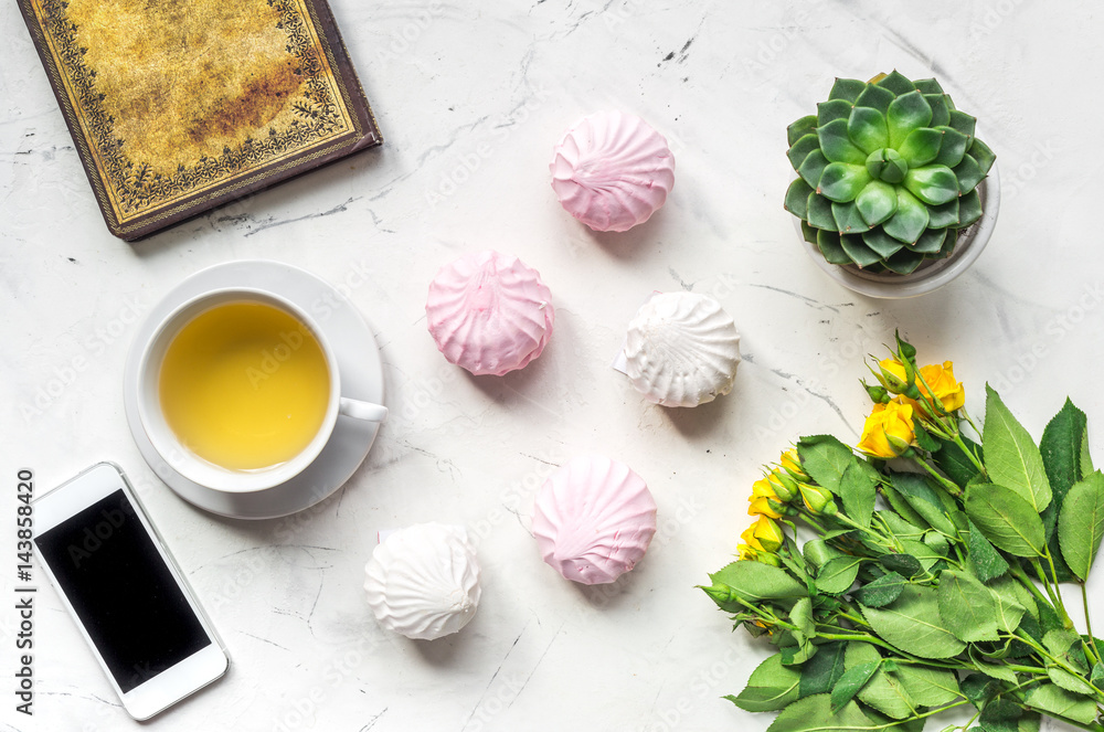 lifestyle concept with tea and roses on home desk top view