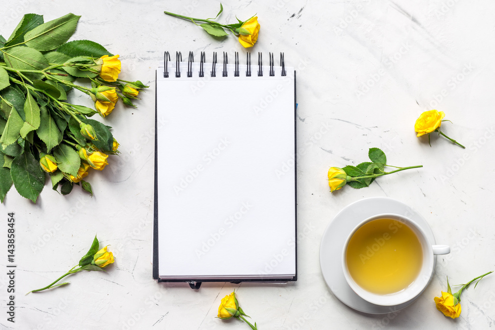 lifestyle concept with tea and roses on home desk top view mock-up