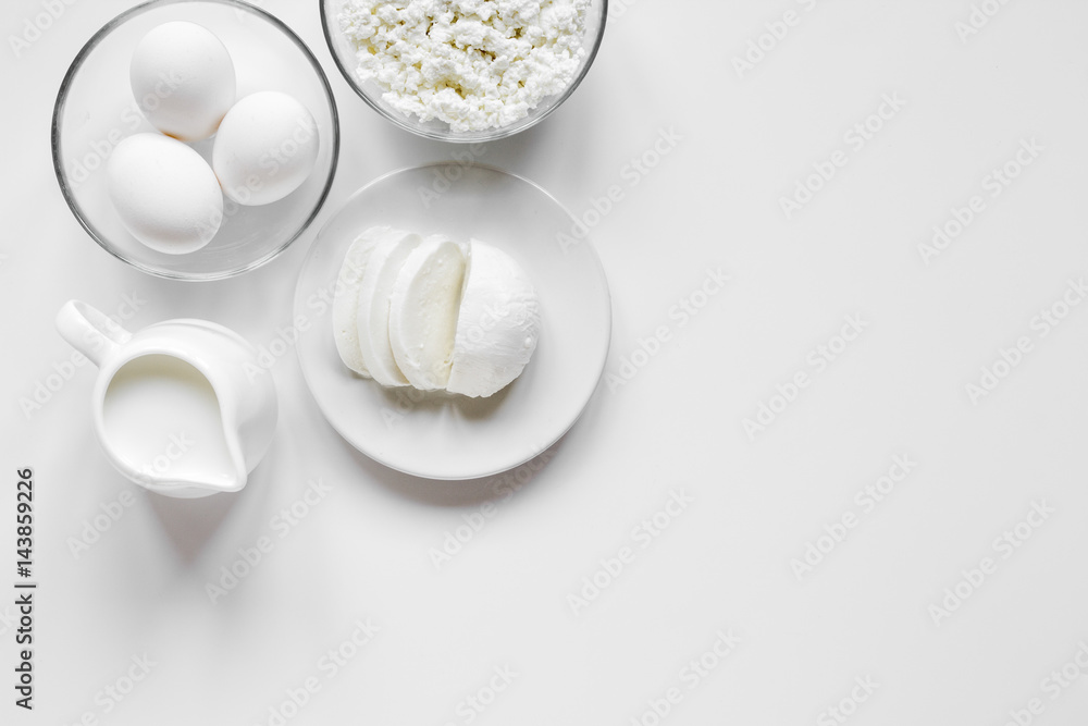 Fresh dairy products on white table background top view mockup