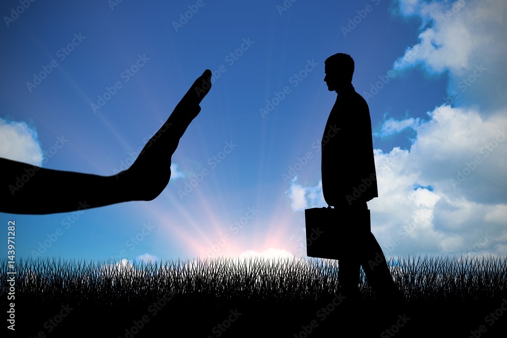 Composite image of handsome businessman holding a suitcase