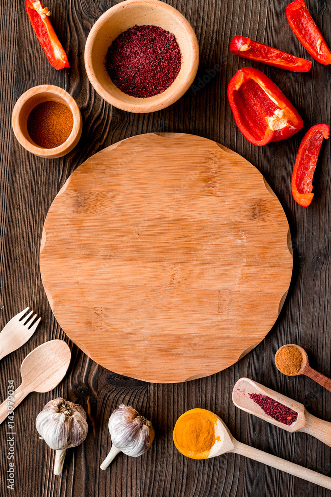 Cook workplace with kitchen tools and sweet pepper wooden background top view