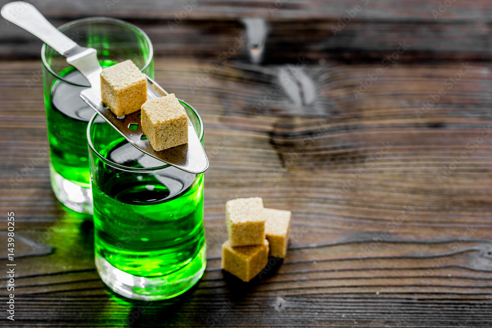 green shots with sugar in spoon on table background space for text