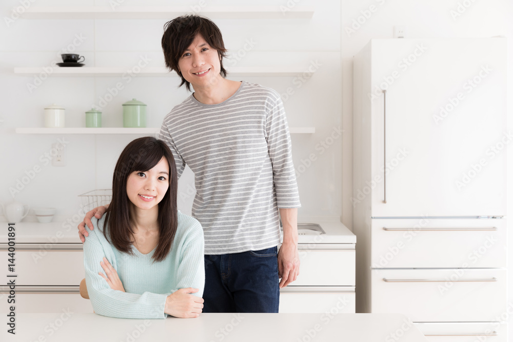 young asian couple relaxing in kitchen