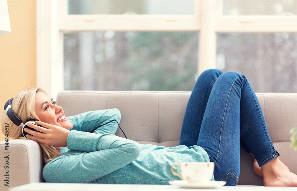 Young woman listening to music on headphones