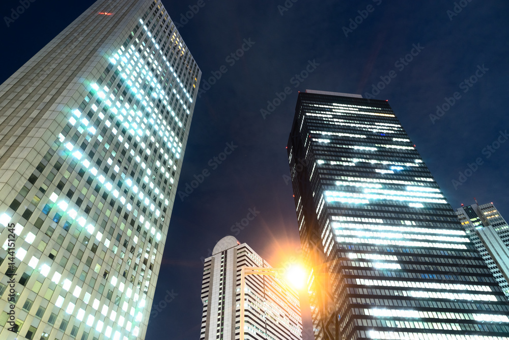 modern office buildings in midtown of tokyo at night