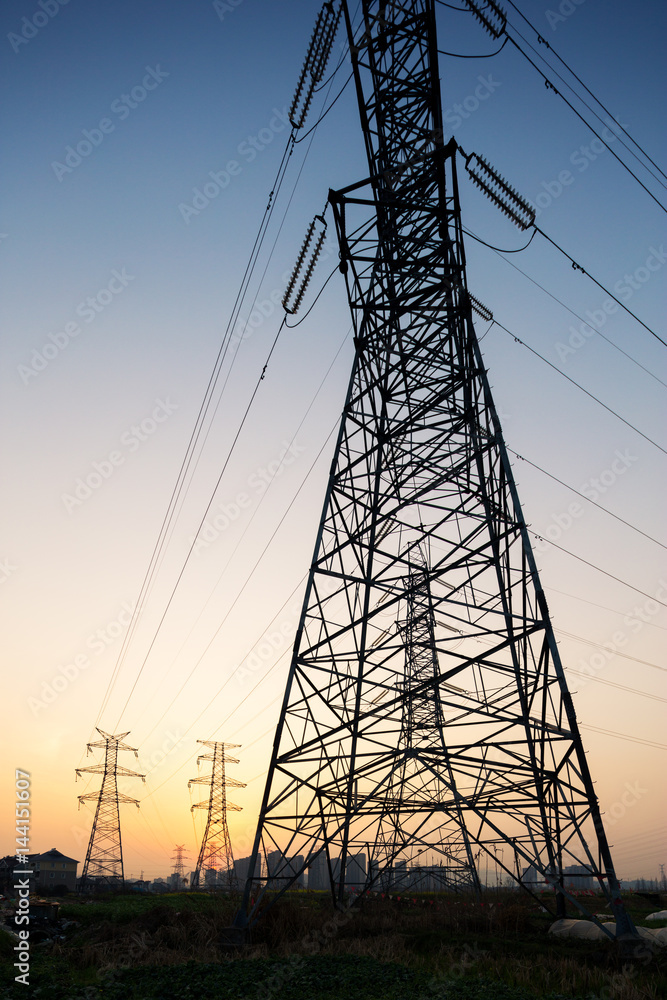 pylons in blue sky at sunrise