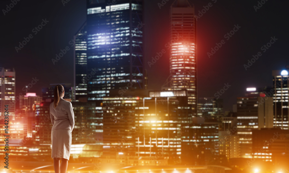 Woman looking at night city