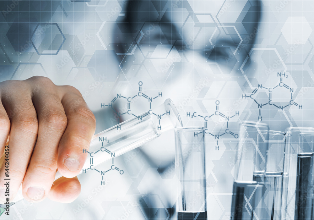 Portrait of concentrated male scientist working with reagents in laboratory