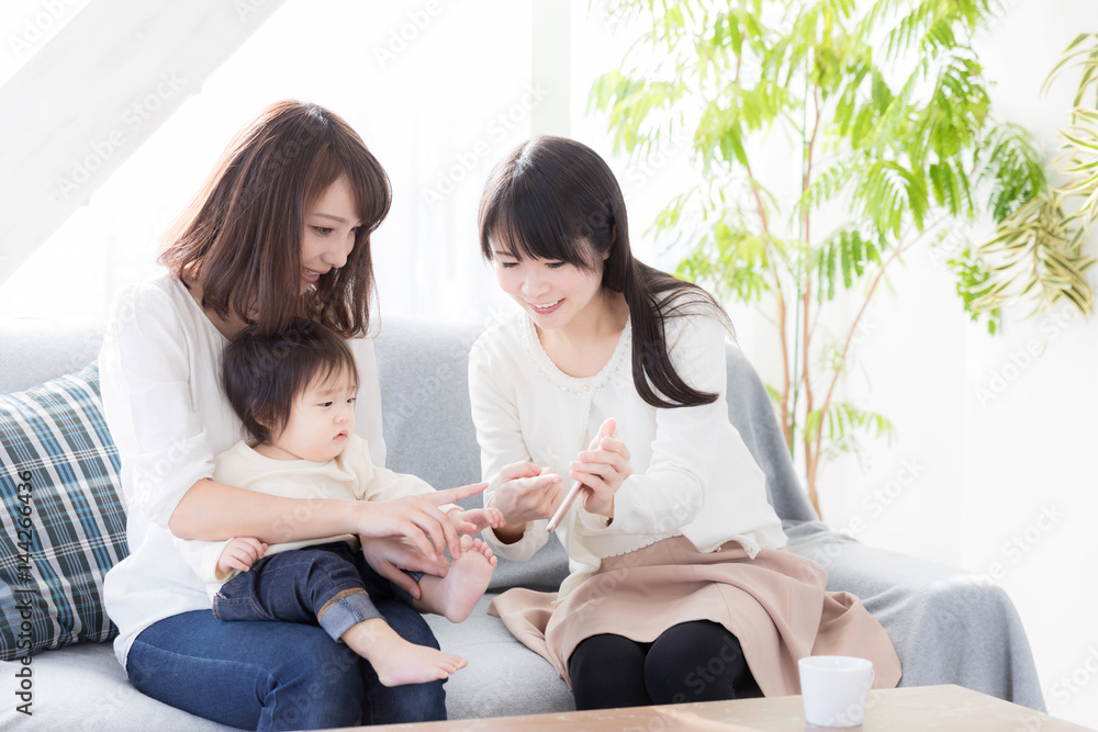 young asian family using smart phone in living room