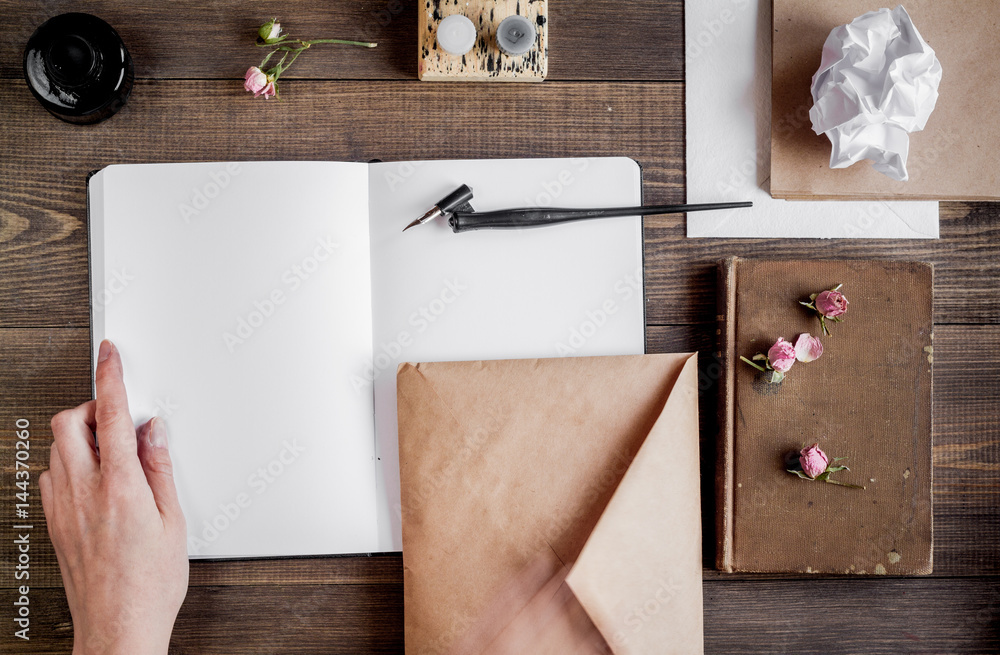 writer workplace with tools on wooden background top view