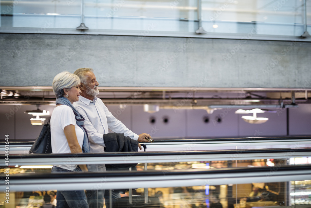 Senior couple traveling airport scene