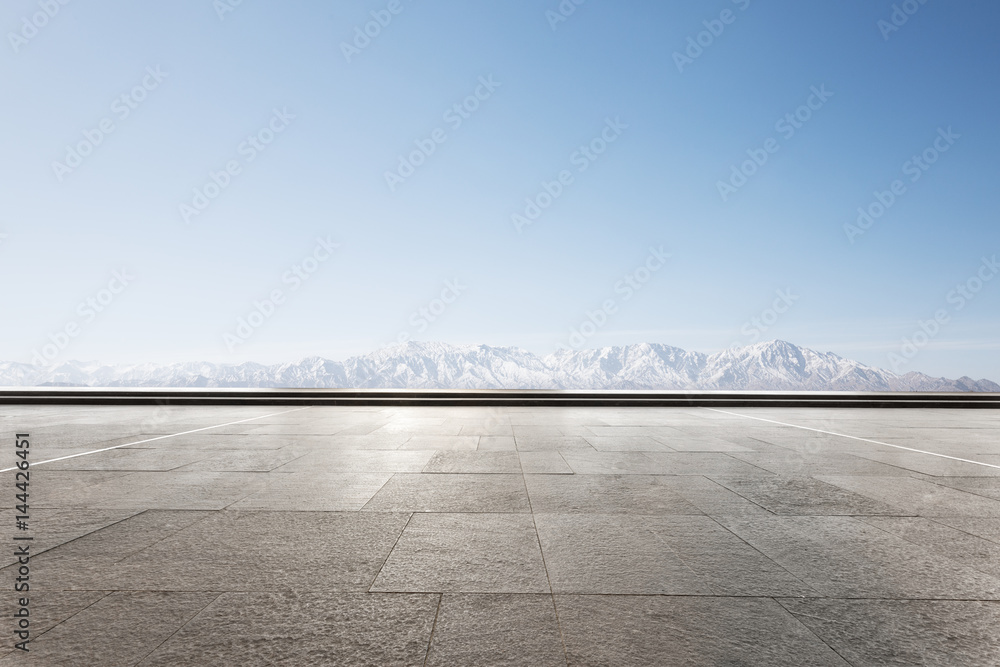 empty floor with white snow mountain