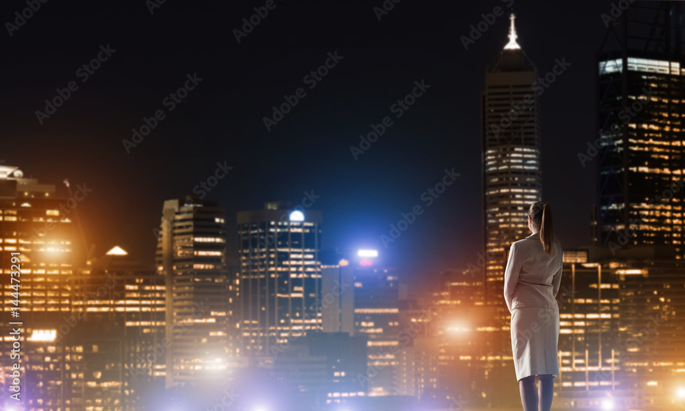 Woman looking at night city