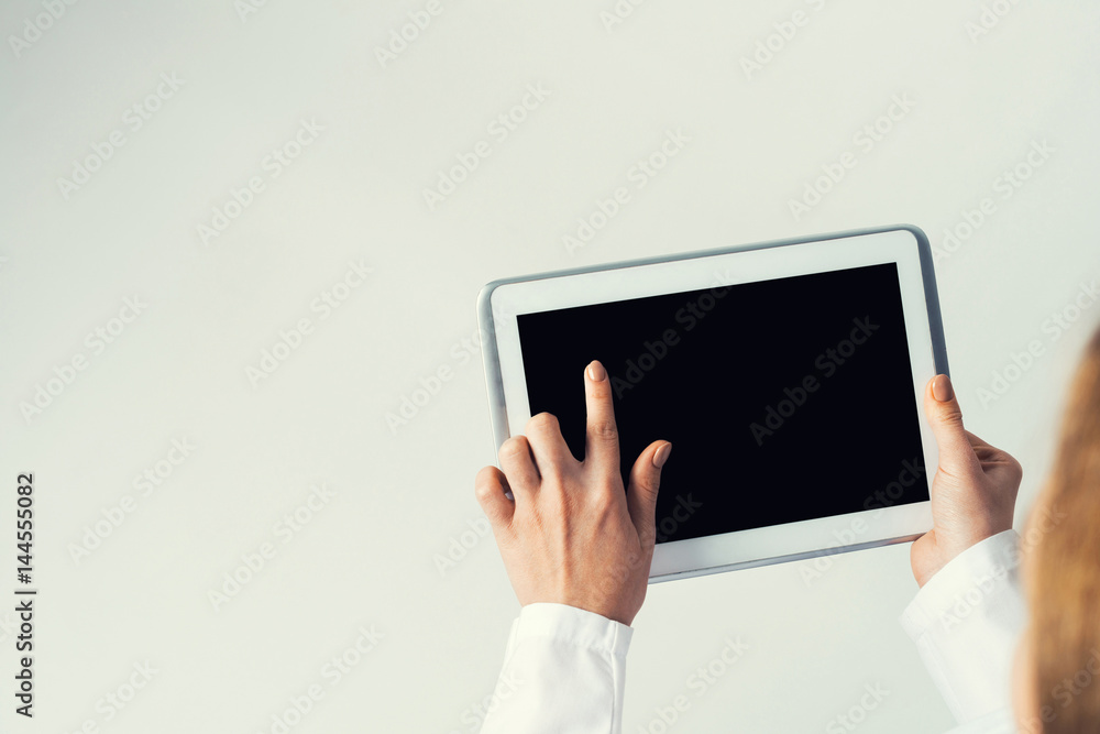 Close of female doctor hands working with tablet pc computer