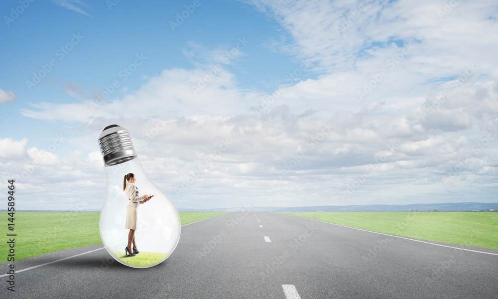 Businesswoman inside light bulb