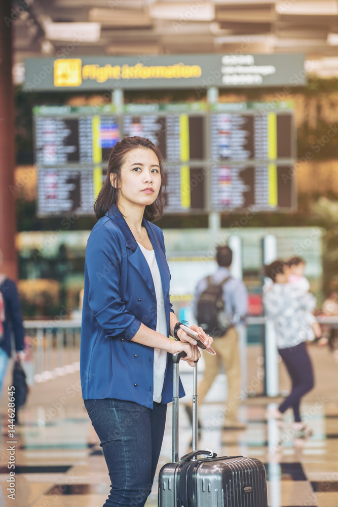 Tourist woman with luggage in the airport