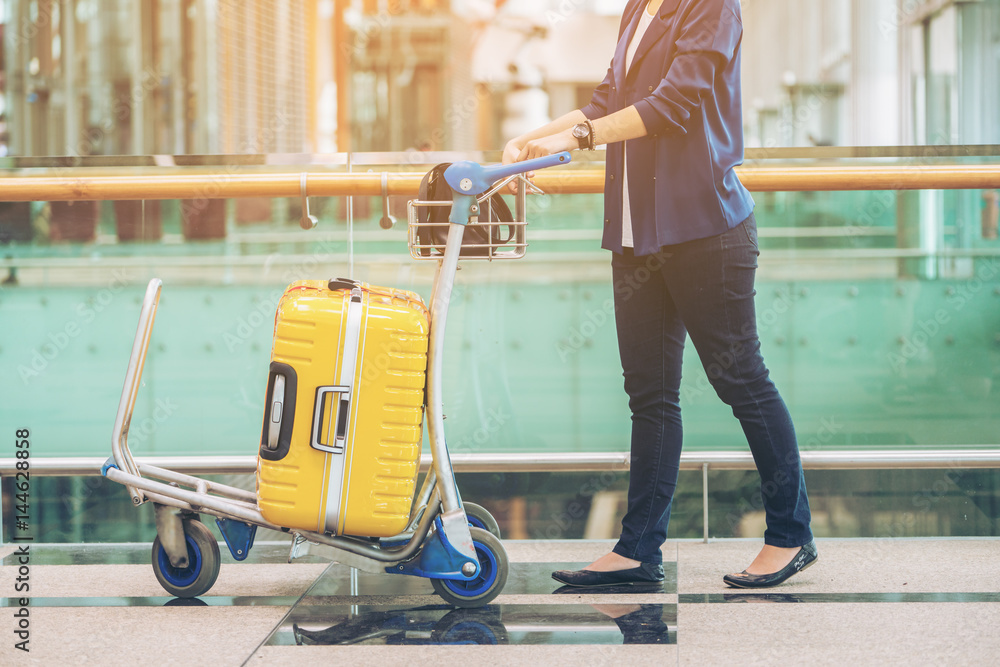 Tourist woman in the airport terminal with luggage