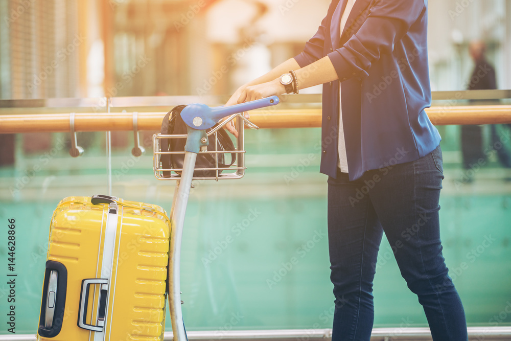 Tourist woman in the airport terminal with luggage