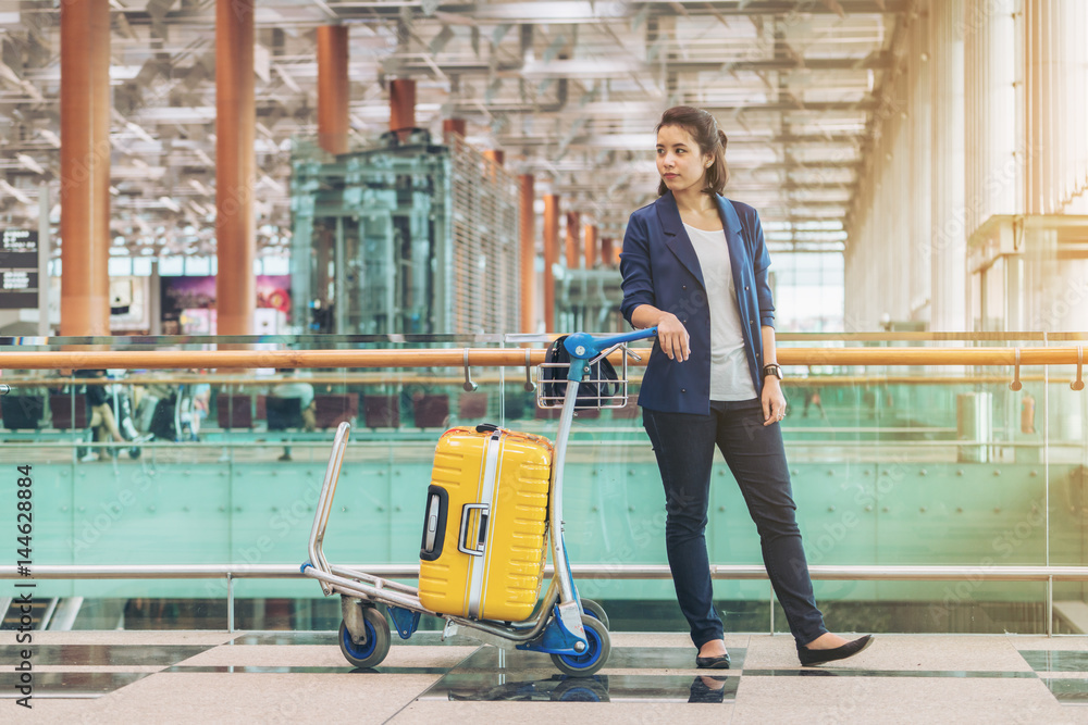 Tourist woman in the airport terminal with luggage