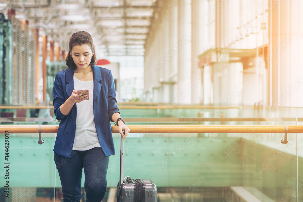 Tourist woman in the airport terminal with luggage