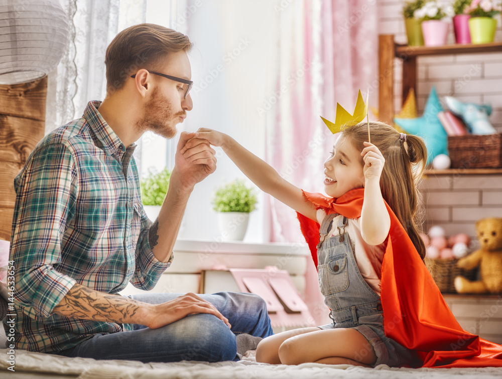 Dad kisses hand of his daughter