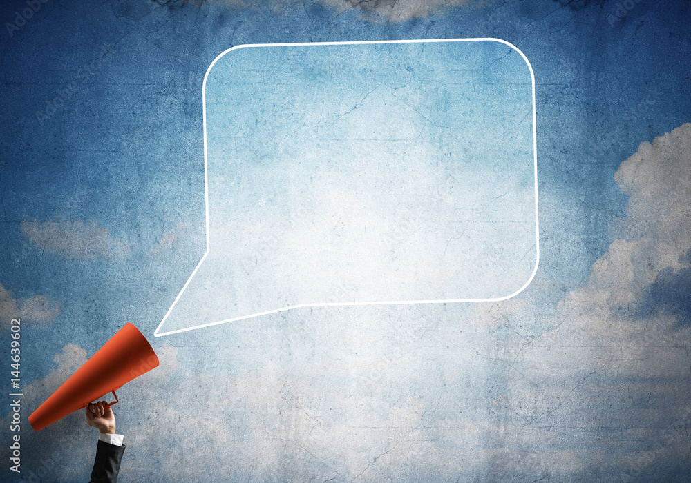 Hand of businesswoman holding red paper trumpet and speech cloud