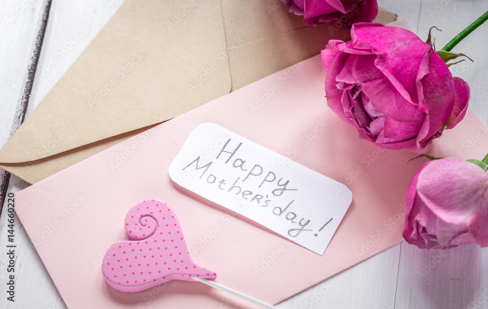 pink peony and greeting-card for Mothers day present on wooden background