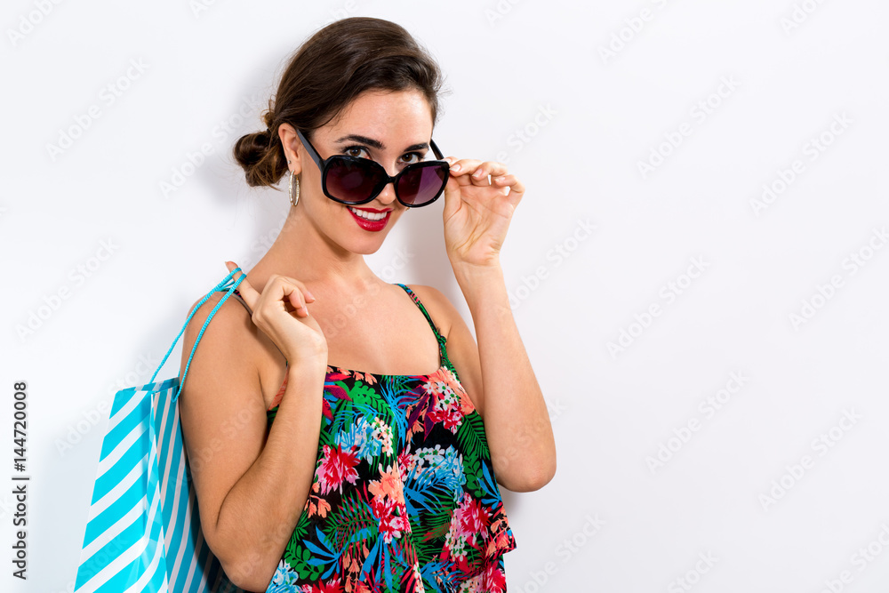 Happy young woman holding a shopping bag