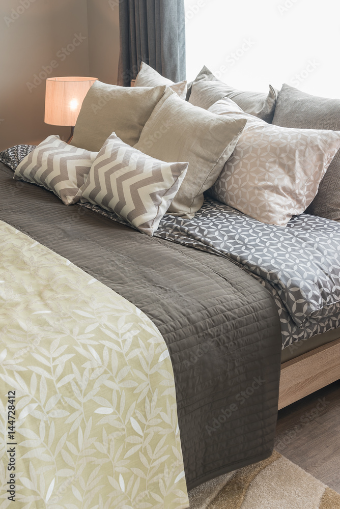 set of pillows on bed in cozy bedroom