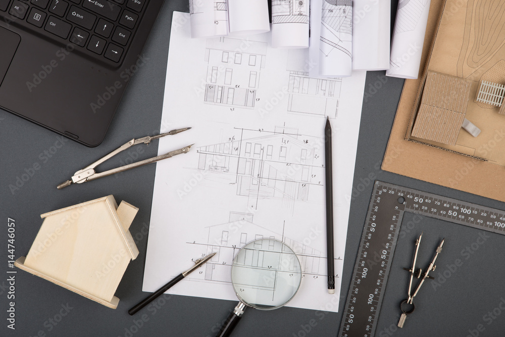 Workplace of architect - construction drawings, scale model and tools