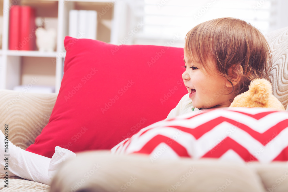 Toddler girl laughing in her living room