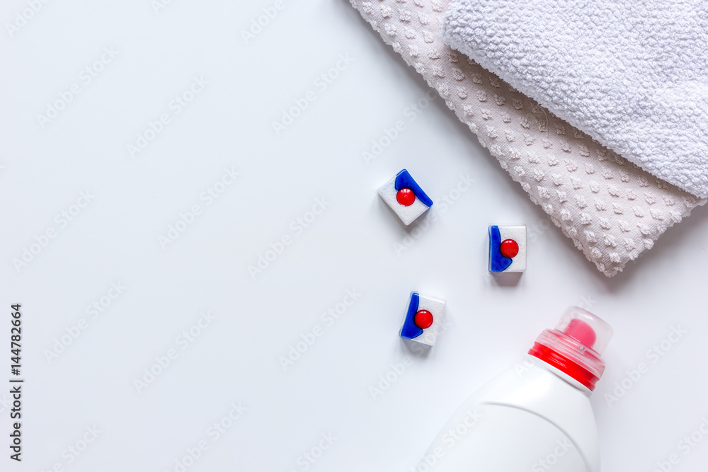 housekeeping set with towels and plastic bottles in laundry top view mock-up