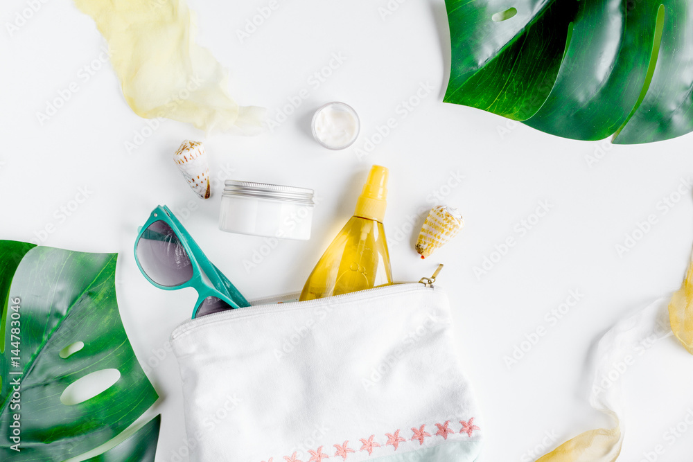 Cosmetic bottle with cream on white background top view