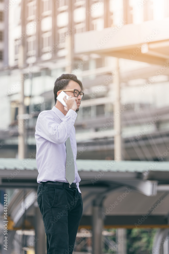 Portrait of.serious man talking on smartphone outdoors. caucasian businessman using mobile phone, ma