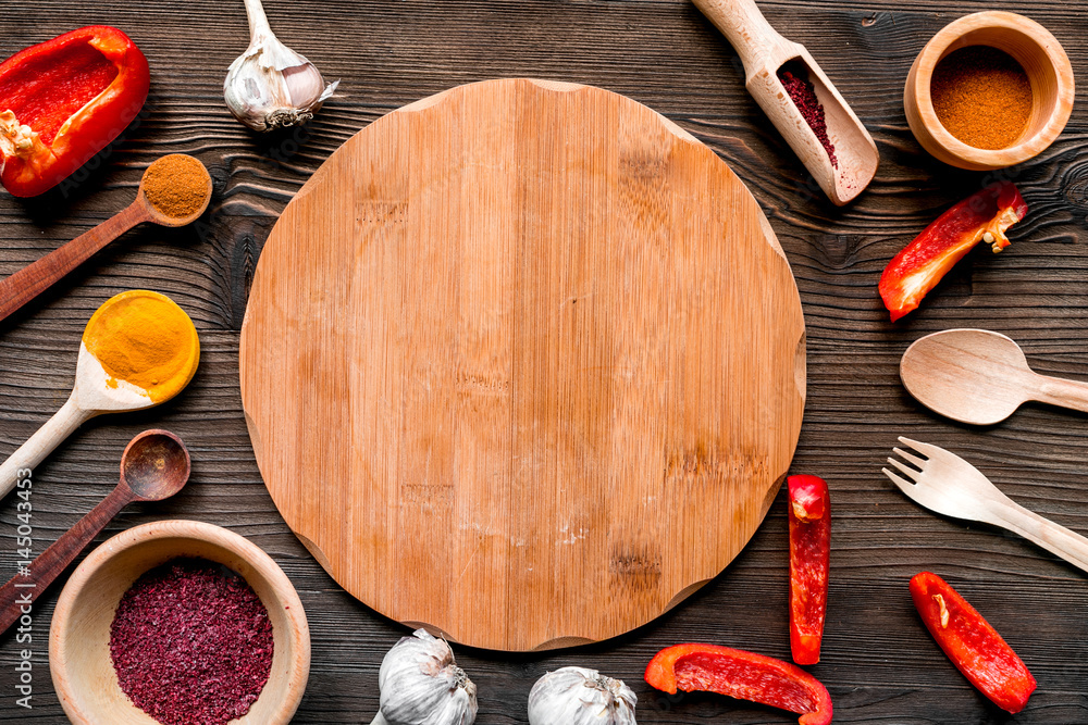 Cook workplace with kitchen tools and sweet pepper wooden background top view