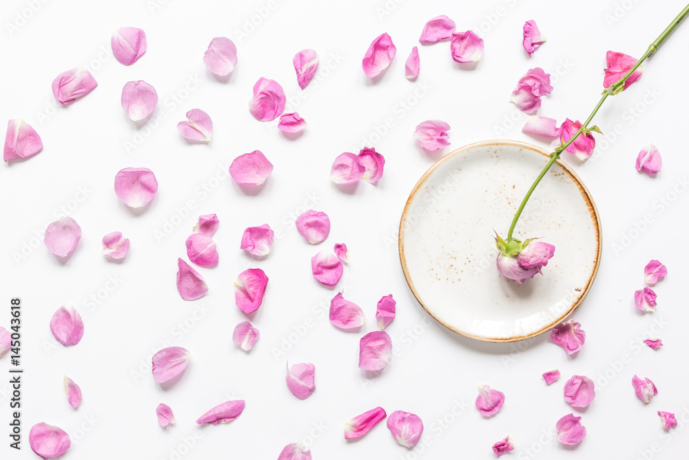 trendy woman desk with rose petals and plate top view mock-up