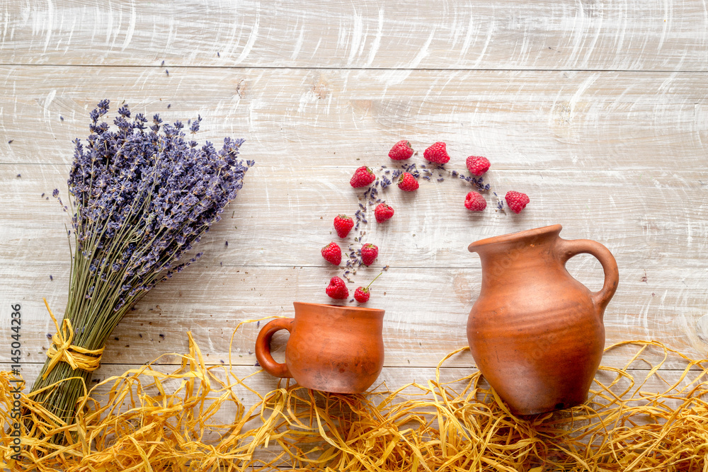 laveder composition with jar, cup, raspberry on rustic background top view mock-up