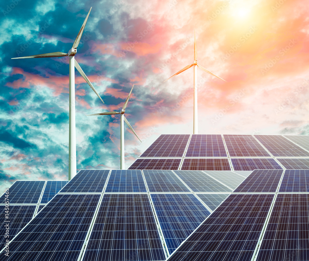 solar panels and wind generators at sunset