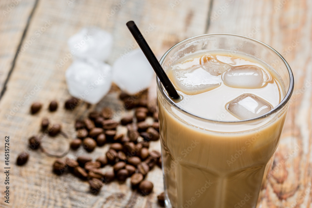 iced coffee with beans for cold summer drink on wooden background