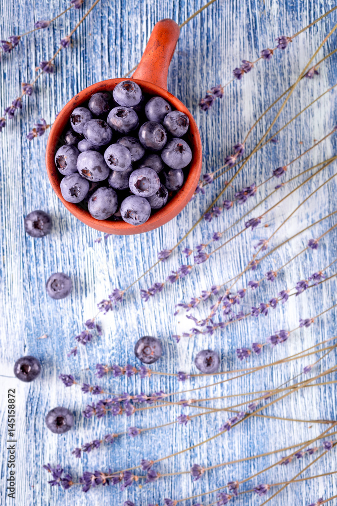 blueberry design with cup and lavender blue rustic background top view mockup