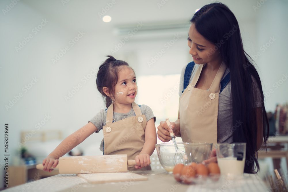 mother and daugthter cooking togather for make bread for dinner