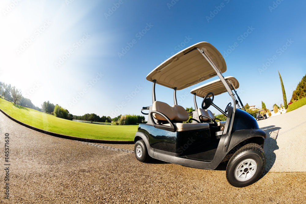 Car park with two golf-carts at sunny day