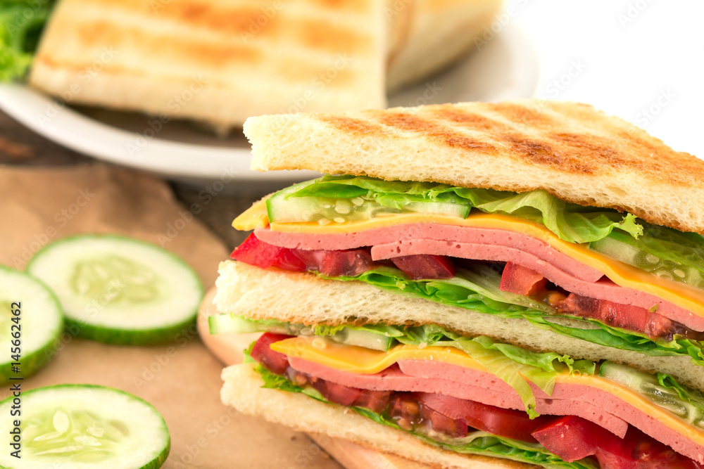 Sliced Grilled sandwiches bread with bacon , ham and cheese with vegetable , healthy breakfast