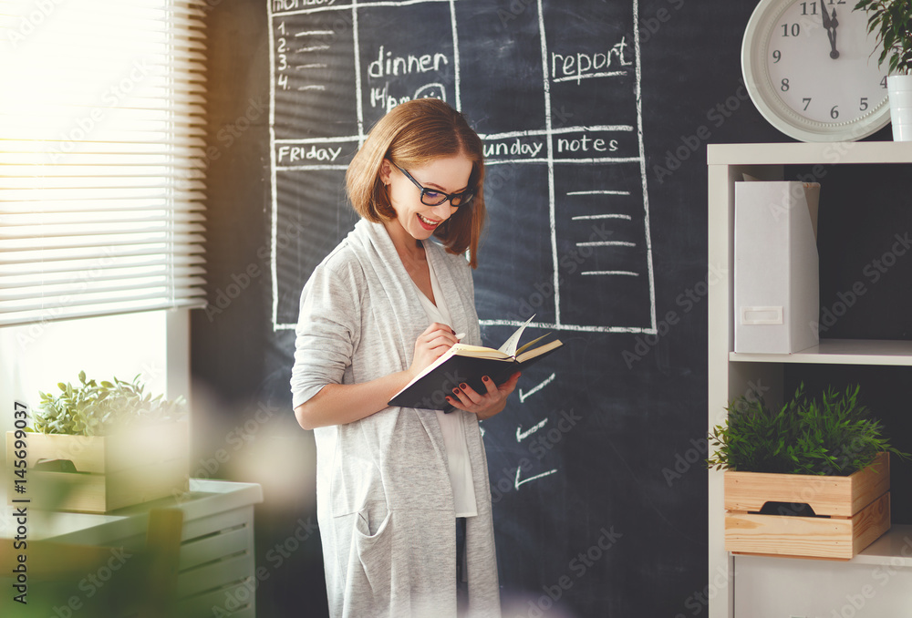 Happy businesswoman woman at school board with schedule planning